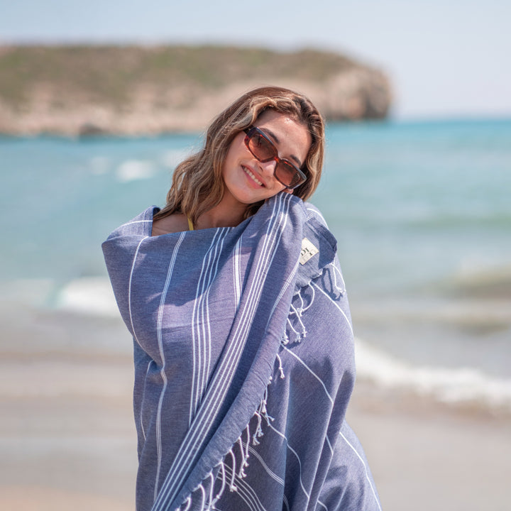 Navy Turkish cotton beach towel on the beach in Antalya, Turkey